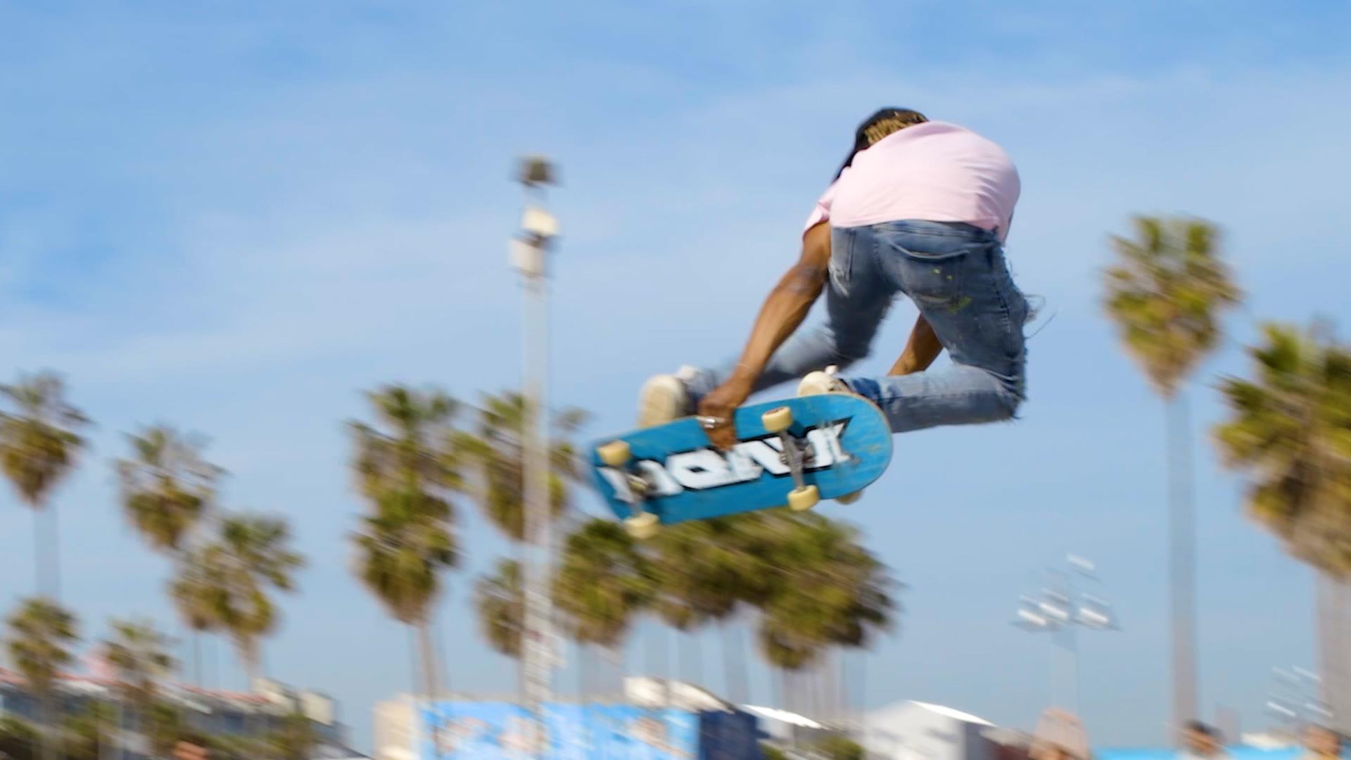 A skateboarder launching into the air at the Venice skate park
